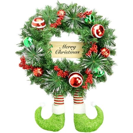 a christmas wreath with stockings and candy canes