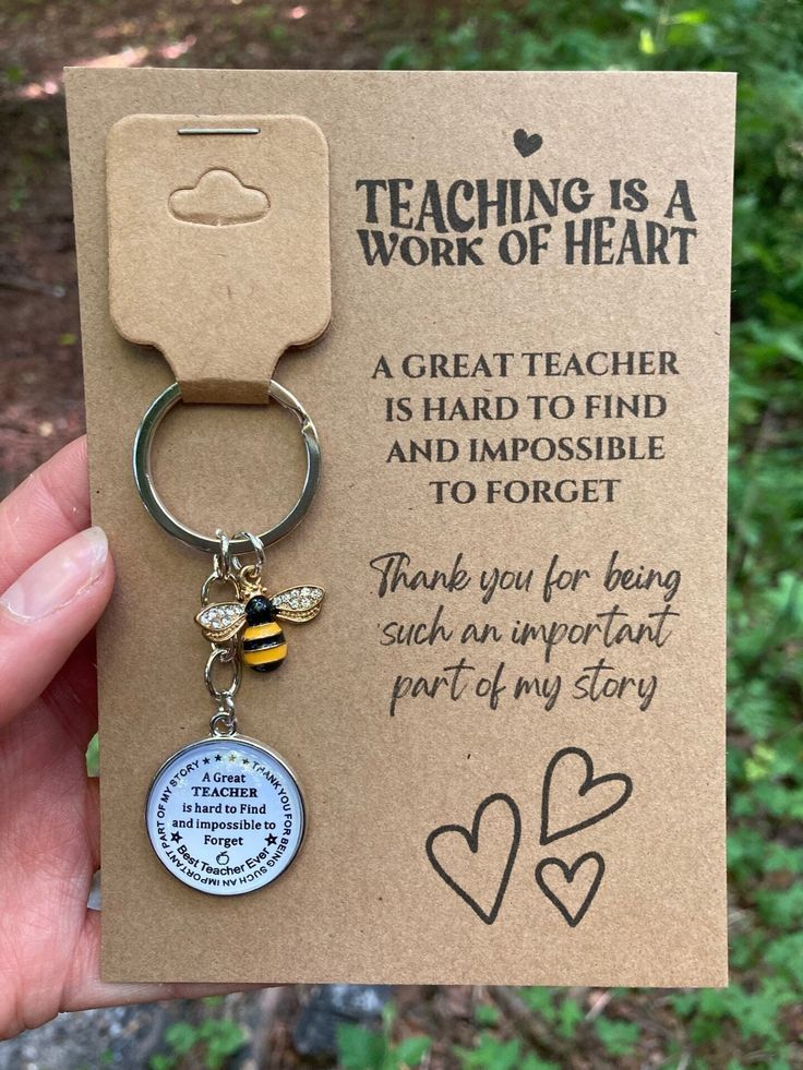 a card with a keychain that says teaching is a work of heart