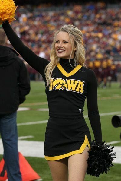 a woman in a cheerleader uniform holding a pom - pom