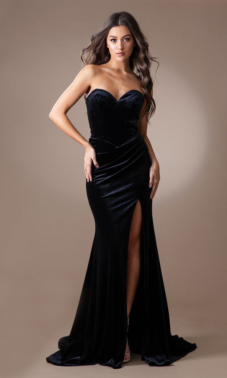 From Amelia Couture, this long velvet prom dress is a timeless style that is sure to wow the crowd. The strapless long formal dress is crafted in rich velvet material from the sweetheart neckline to the hem for a polished look at prom, fancy wedding receptions, and other black-tie events. With tummy-camouflaging ruching at the waist, this long velvet evening gown smooths over the hips before opening in a side slit that completes the design. Surprisingly affordable at under $150, this long velvet White Rehearsal Dress, Fitted Prom Dresses Long, Marine Ball, Sweetheart Corset, Velvet Evening Gown, Dama Dresses, Debutante Ball, Corset Boning, Velvet Prom Dress