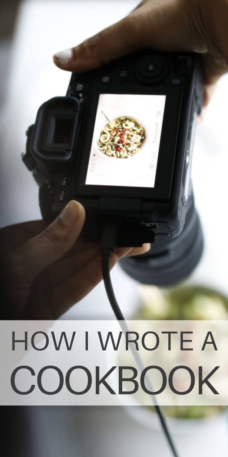 a person holding a camera with the words how i wrote a cookbook