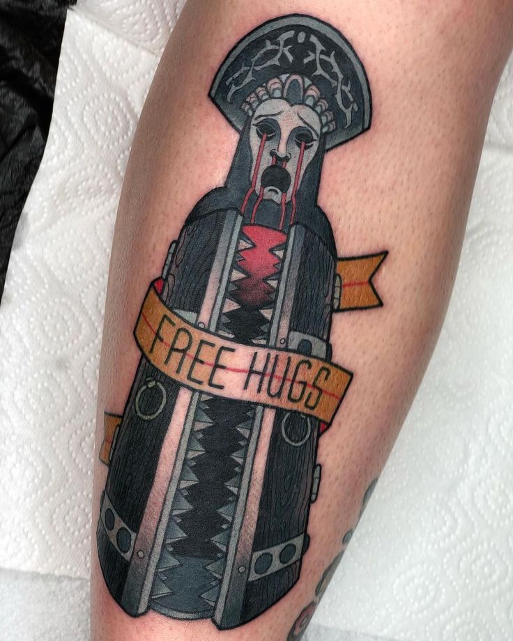 a tattoo on the leg of a person with a knife in his hand and words free hugs