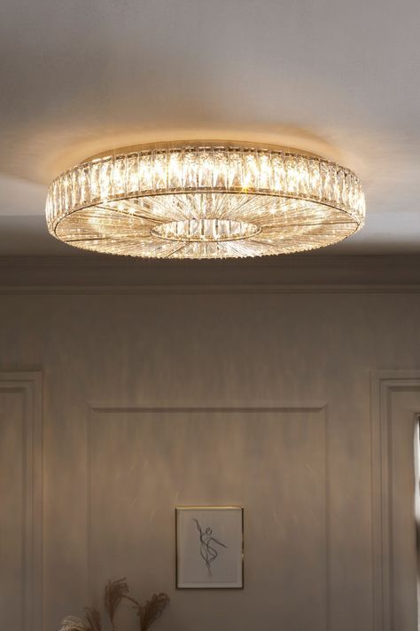 a living room with a couch and a chandelier hanging from it's ceiling