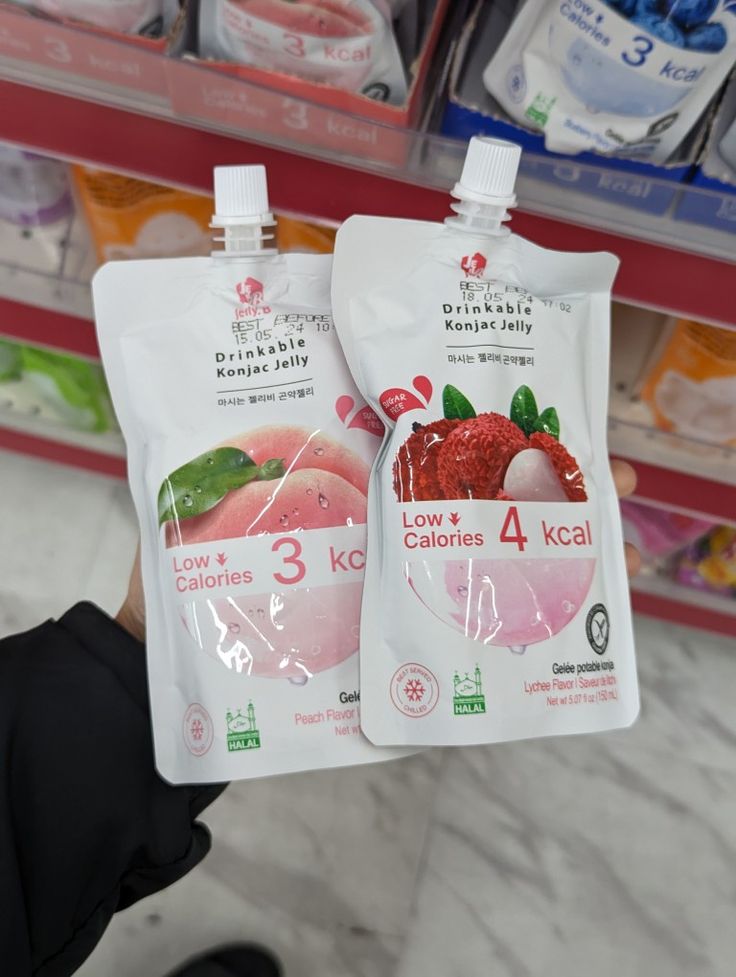 two bags of frozen fruit sitting on top of a store shelf