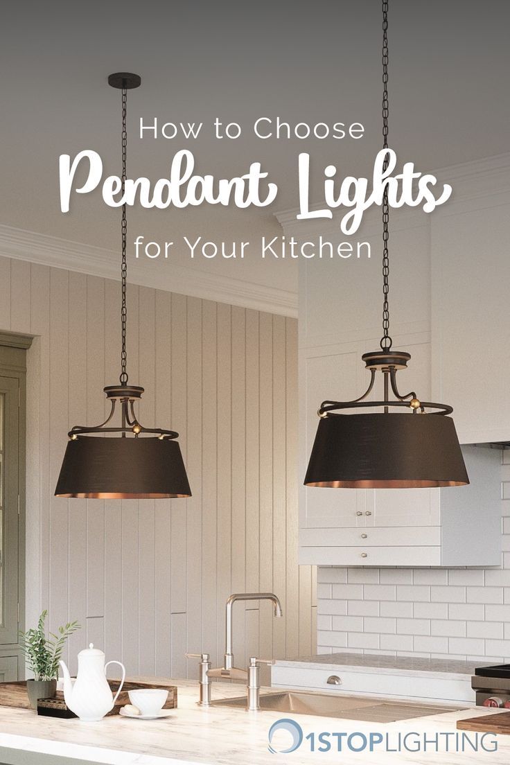 two pendant lights hanging over a kitchen island