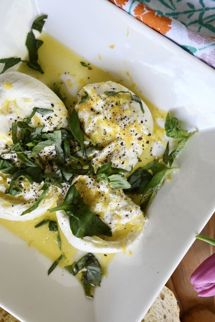 an egg dish on a white plate with herbs