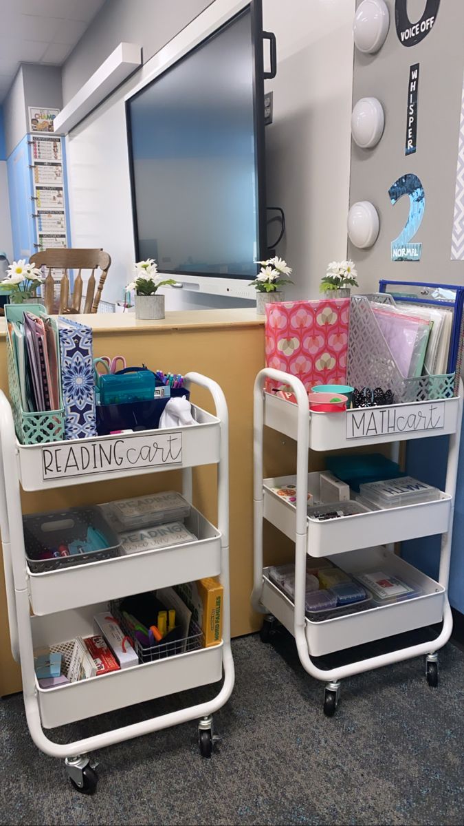 two white rolling carts filled with books and magazines