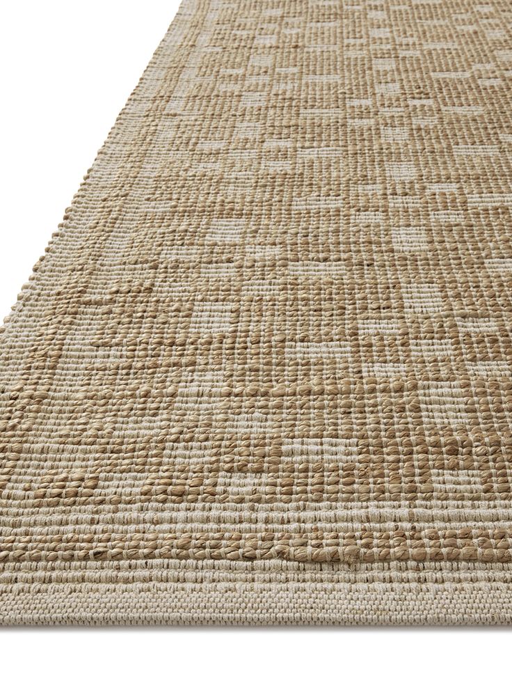 an area rug made out of jute and woven with white stitching on it