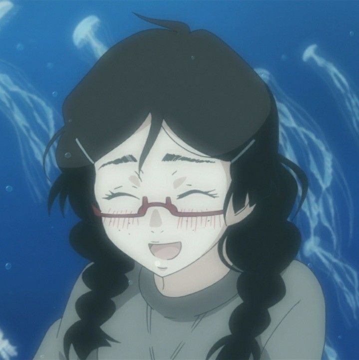 a girl with her eyes closed in front of jelly fish