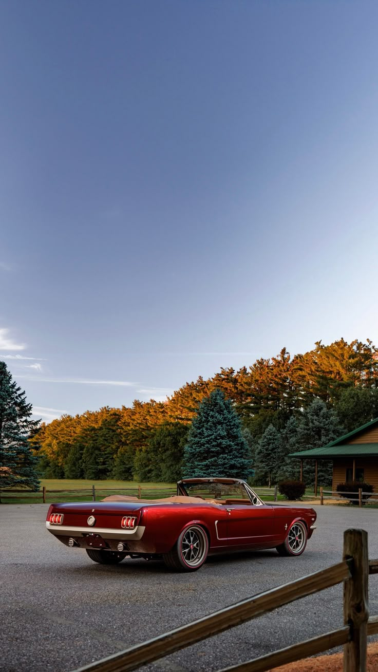 an old red car is parked in the parking lot