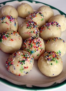 a white plate topped with donuts covered in sprinkles