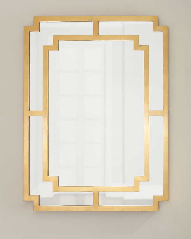 a gold framed mirror on the wall