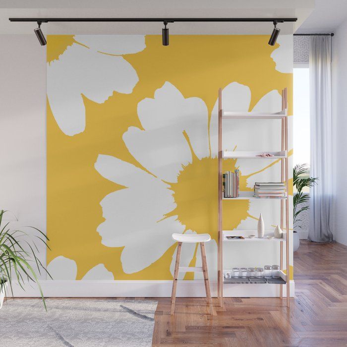 a yellow and white flower wall mural in a living room with wooden floors, bookshelf