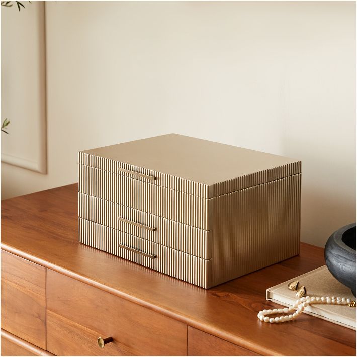 a brown box sitting on top of a wooden dresser