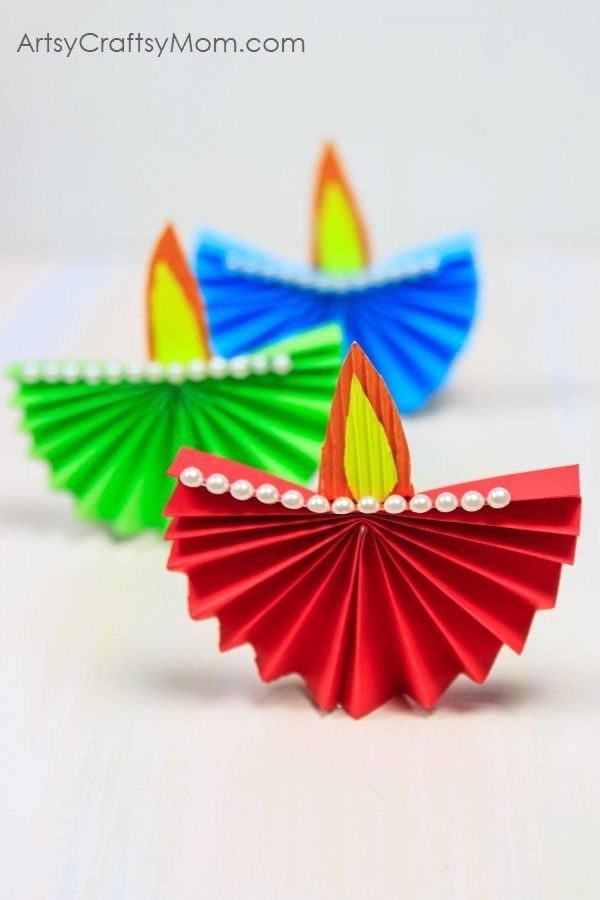 an image of two colorful paper diyas on the web page for artsy com