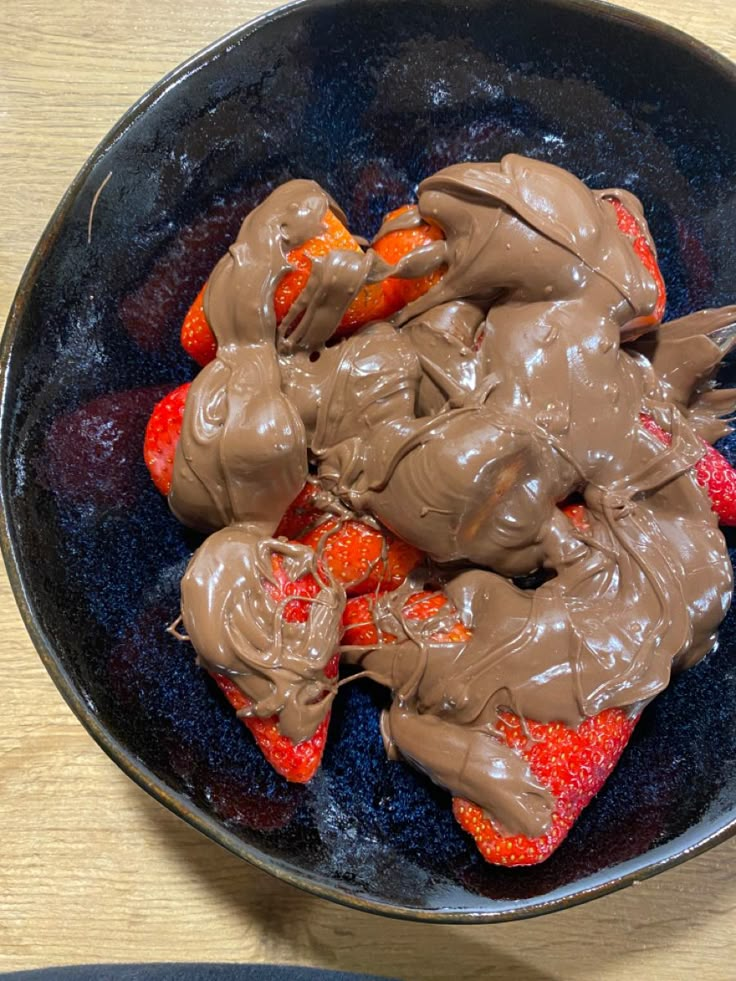 chocolate covered strawberries in a bowl on a table