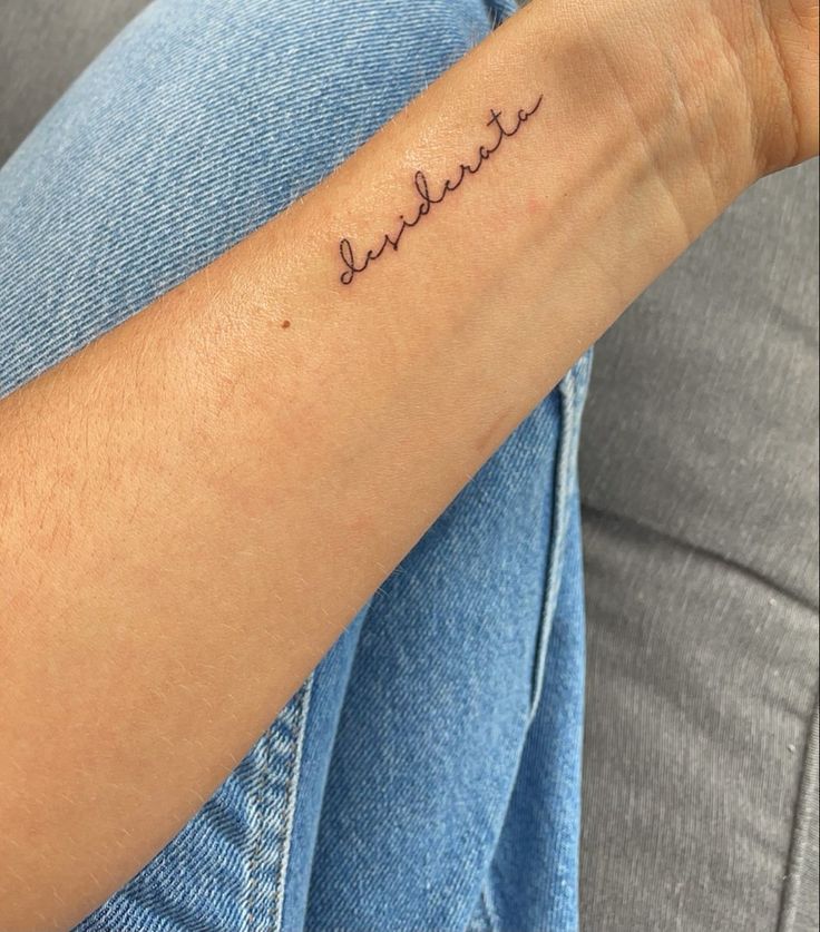 a woman's arm with a tattoo that reads, believe