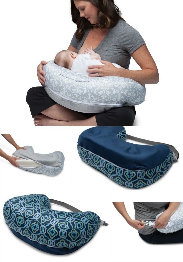 a woman is holding a baby in her arms and it's on the pillow