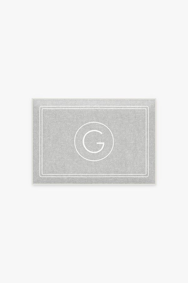 a business card with the letter b in white on a light grey background and an oval monogrammed border