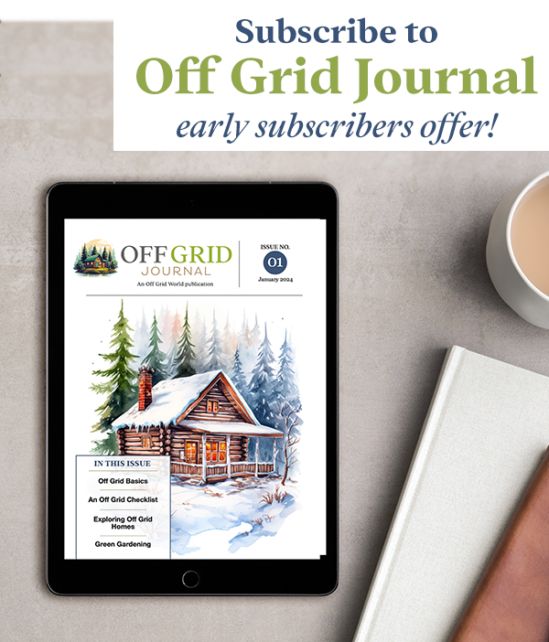 the off grid journal is on top of a tablet next to a cup of coffee