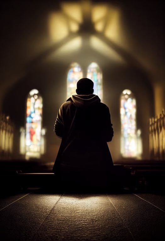 a person sitting on a bench in front of stained glass windows at night with their back to the camera