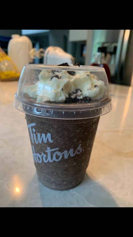 a plastic cup filled with ice cream and chocolate