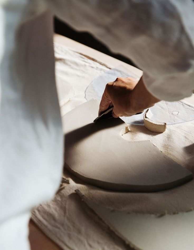 a person is cutting paper with a knife