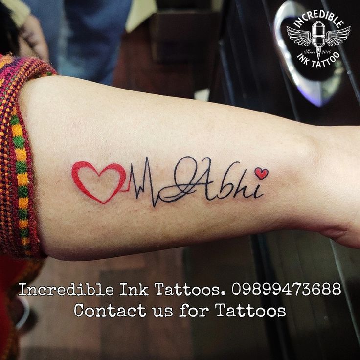 a woman's arm with a tattoo that reads incredible ink tattoos, contact us for tattoos