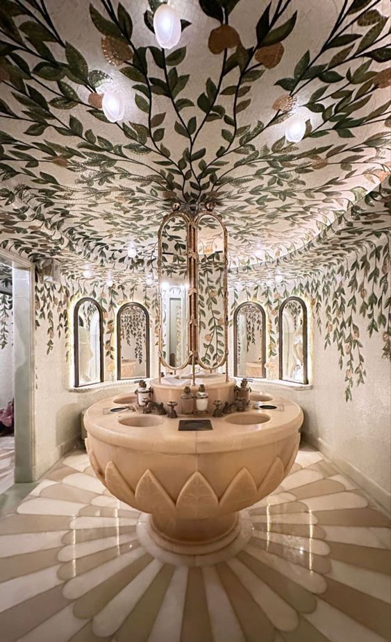 a fancy bathroom with a fountain in the center and mirrors on the wall above it