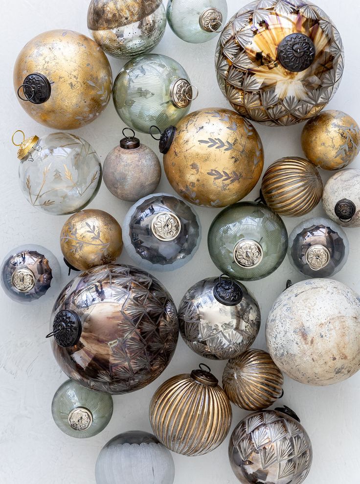 an assortment of glass ornaments on a white surface