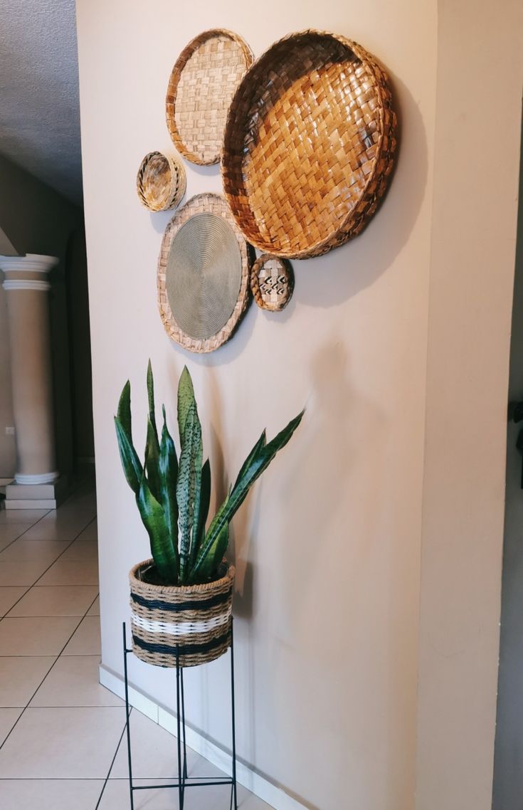 a potted plant sitting on top of a metal stand in front of a wall