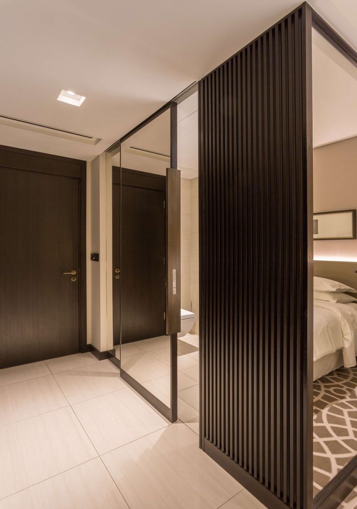 the interior of a modern bedroom with mirrored walls and floor to ceiling closet doors that are open