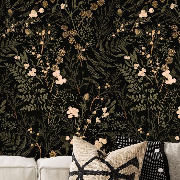 a living room with a white couch and black wallpaper that has flowers on it