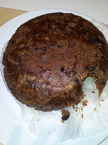 a piece of chocolate cake sitting on top of a paper plate covered in tin foil