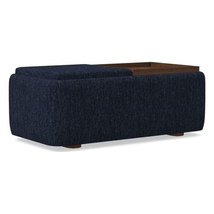 a blue couch sitting on top of a wooden table