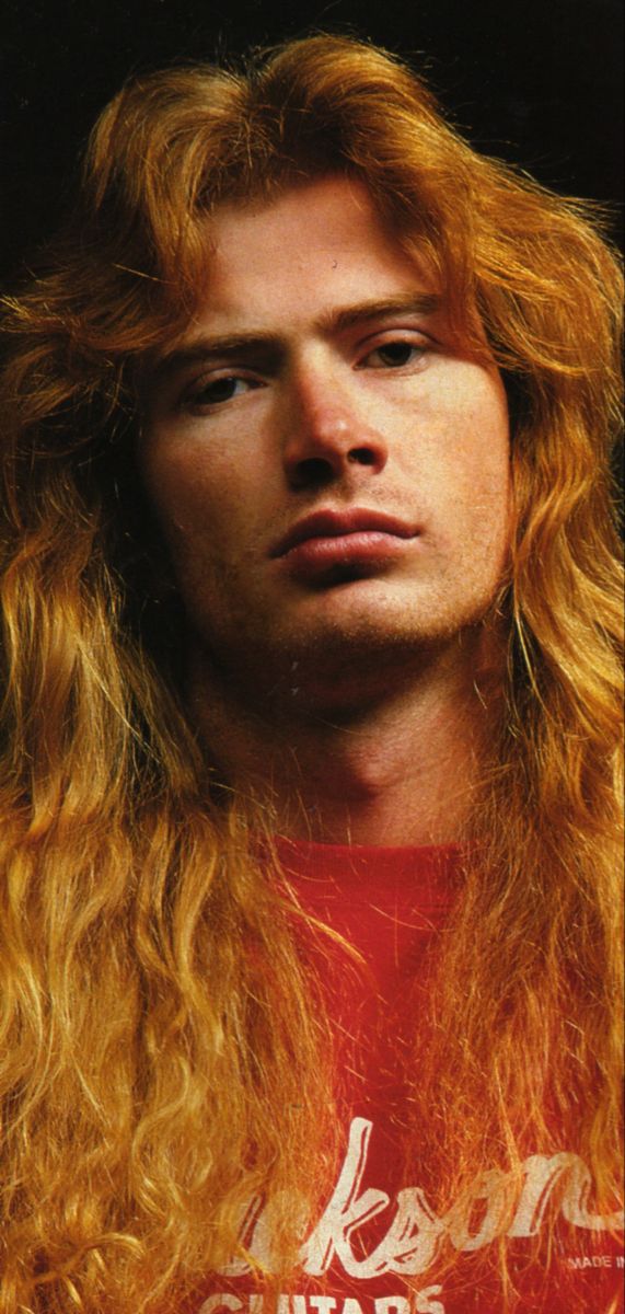 a man with long red hair wearing a red shirt