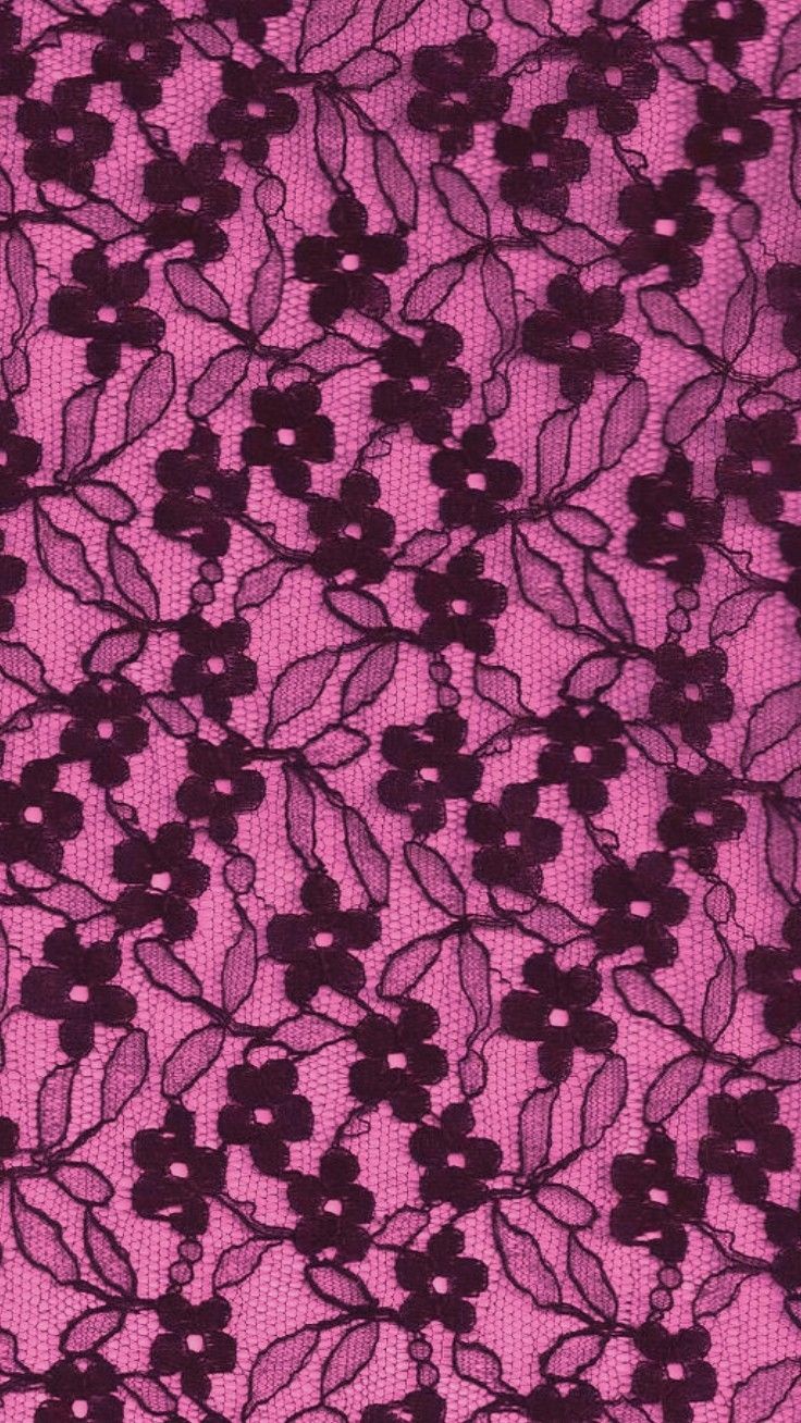 an image of a pink and black lace fabric with flowers on the side, close up