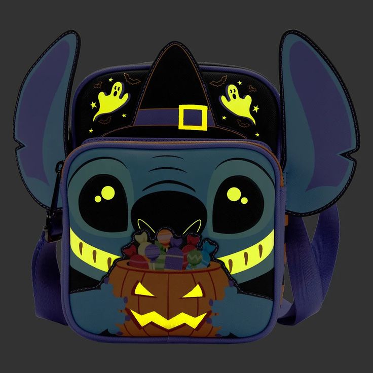 This trickster is ready for a sweet treat! Unwrap some festive fun with the Loungefly Lilo and Stitch Glow Halloween Candy Cosplay Passport Bag. On the front zipper pocket, Stitch grins down at a pumpkin-shaped basket filled with treats. Up above, a witch hat sits between his ears. Turn down the lights to see spooky, glow-in-the-dark details come to life! On the back of the bag, Stitch says the phrase “Gimme candy!” while visiting some friendly haunts. This confectionary crossbody bag will add e Lilo En Stitch, Disney Universe, Lounge Fly, Disney Bags Backpacks, Glow Halloween, Stitch Tattoo, Stitch Halloween, Cute Mini Backpacks, Disney Bags