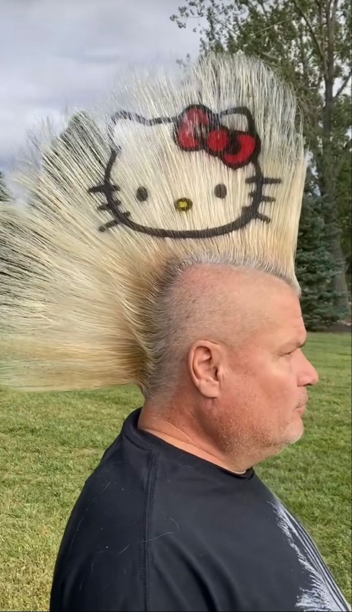 a man with a hello kitty hair style on top of his head