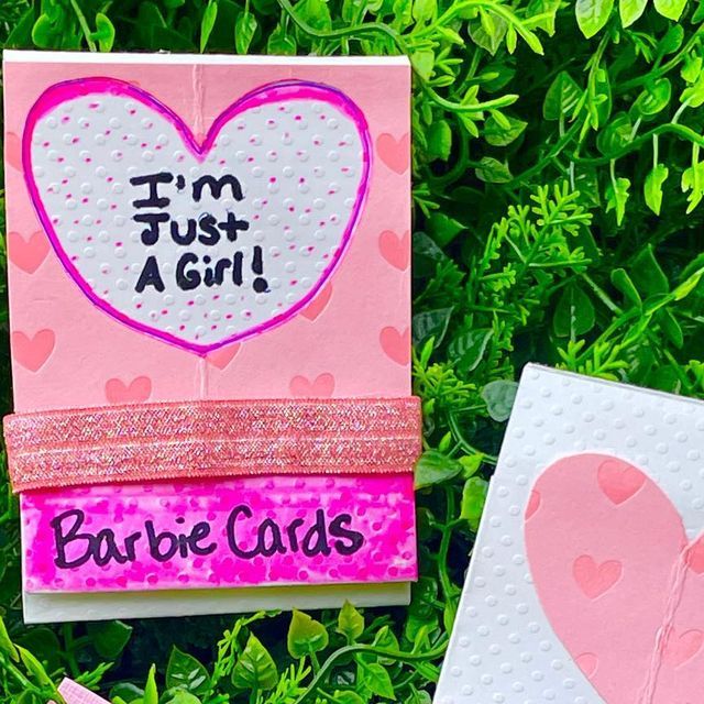 two handmade valentine's day cards sitting in the grass