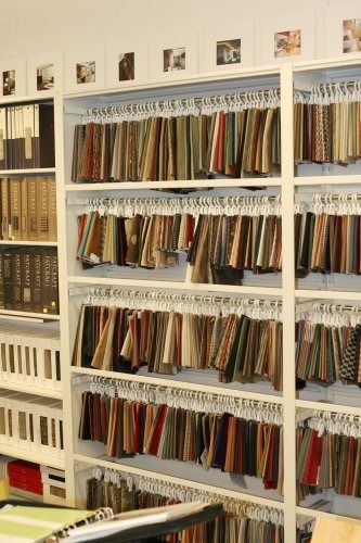 the shelves are filled with many different types of fabrics