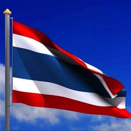 the flag of thailand is flying high in the blue sky with white clouds behind it