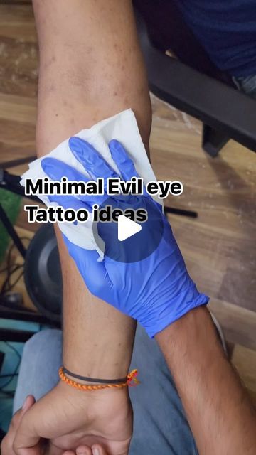 two hands with blue gloves on each hand and the words, minimal evil eye tattoo ideas