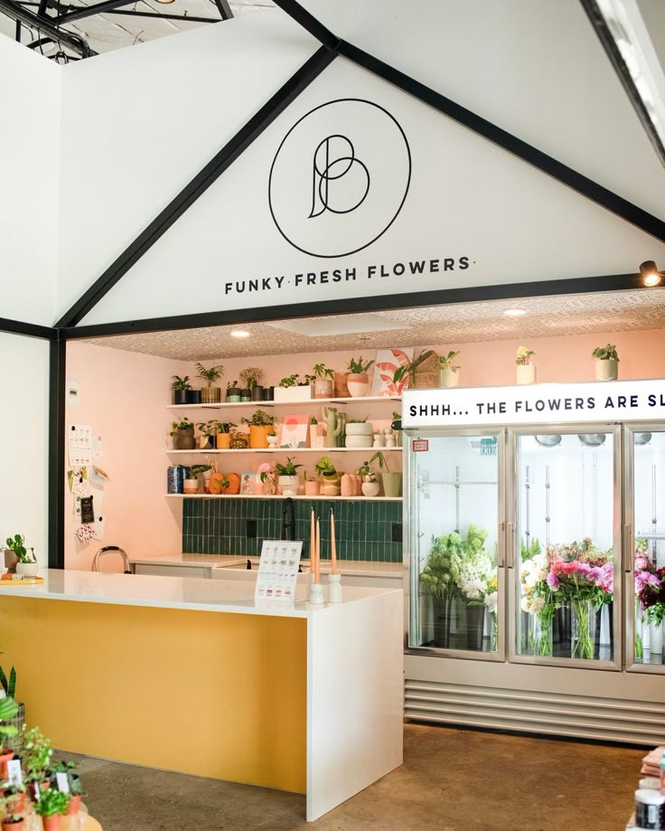 the flower shop is decorated in pink and yellow