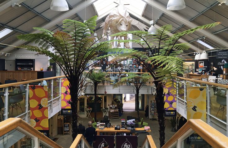 the inside of a large building with lots of plants