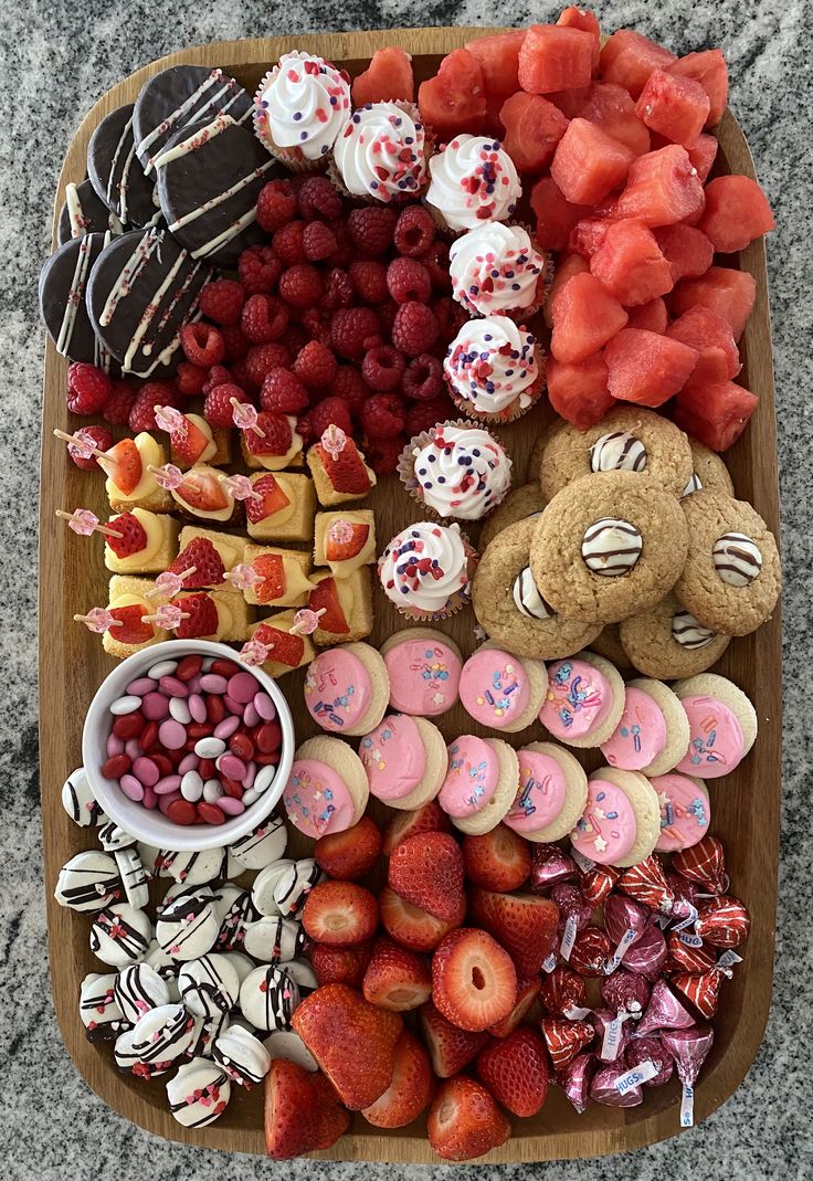 a platter filled with lots of different types of food on top of a table