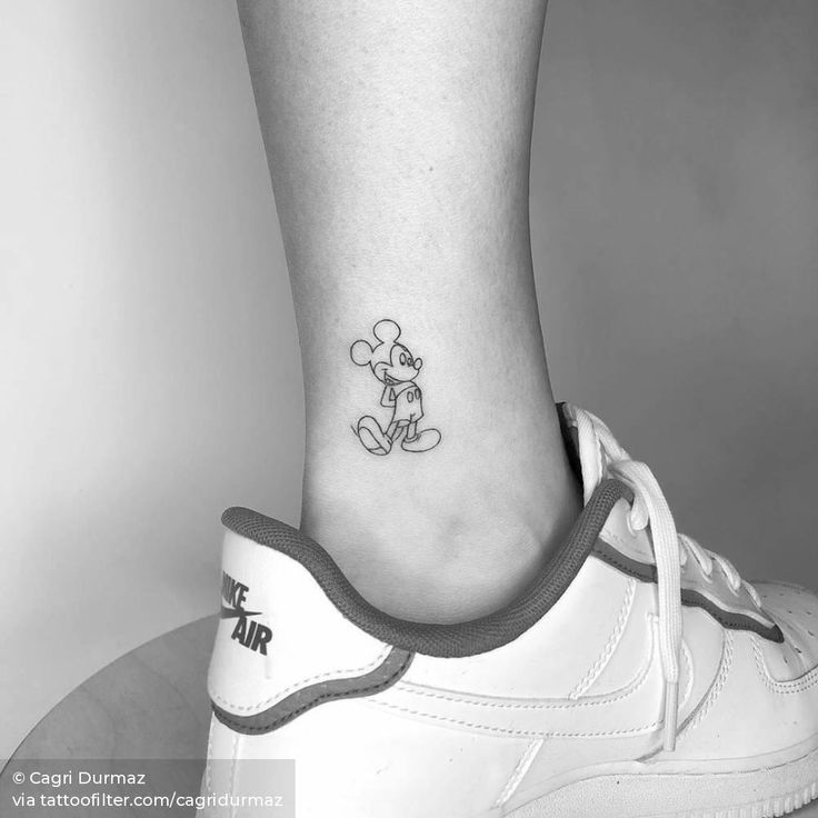 a small mickey mouse tattoo on the ankle