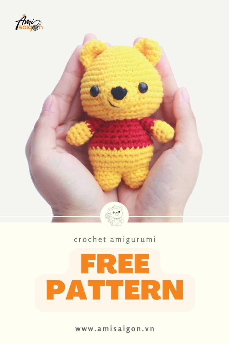 a crocheted winnie the pooh stuffed animal is in someone's hands