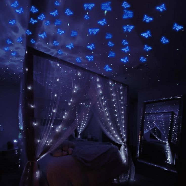 a bed room with a canopy covered in blue lights