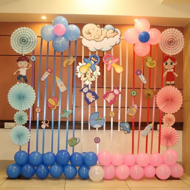 there are many balloons and decorations on the wall